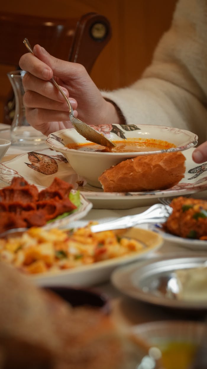 Close-up of a traditional Turkish meal being enjoyed in Gaziantep, Türkiye with various dishes on a table.